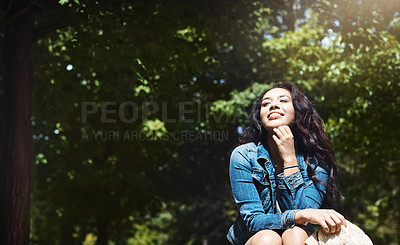 Buy stock photo Shot of an attractive young woman spending a day in the park