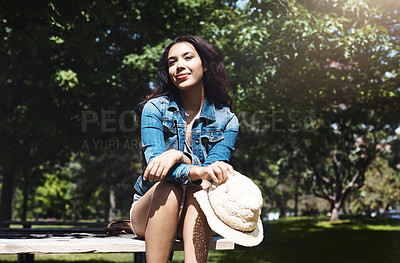 Buy stock photo Shot of an attractive young woman spending a day in the park