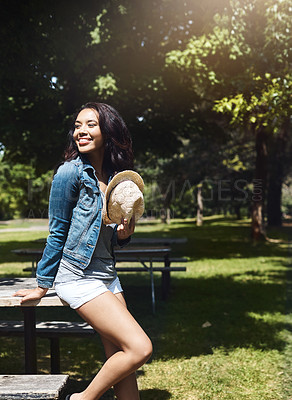 Buy stock photo Shot of an attractive young woman spending a day in the park