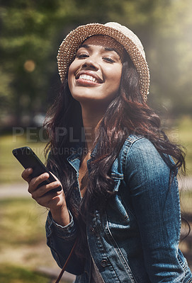 Buy stock photo Portrait of an attractive young woman using a cellphone at the park