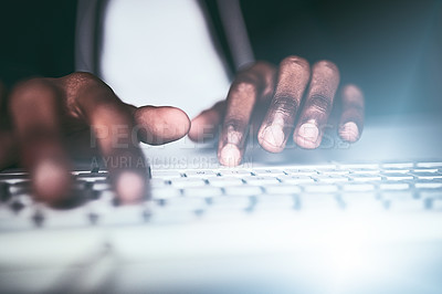 Buy stock photo Closeup shot of an unrecognizable man typing on a keyboard while working late in the office