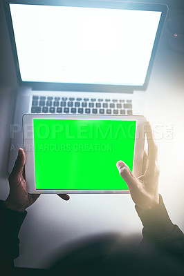 Buy stock photo High angle shot of an unrecognizable man using a tablet while working late in the office