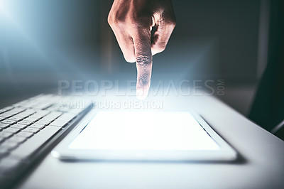 Buy stock photo Closeup shot of an unrecognizable man using a tablet while working late in the office