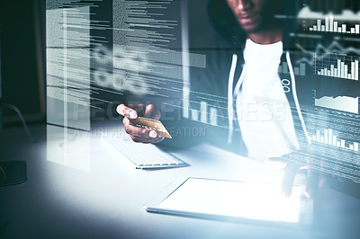 Buy stock photo Cropped shot of a young male hacker cracking a computer code in the dark