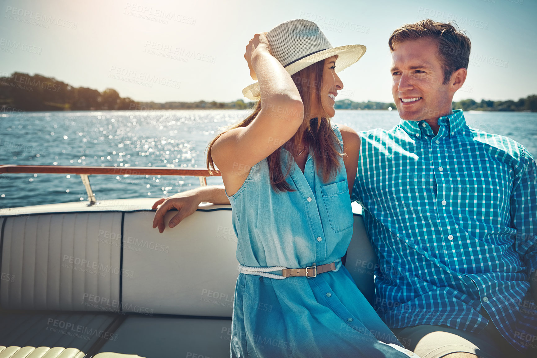 Buy stock photo Shot of a young couple spending time together on a yacht