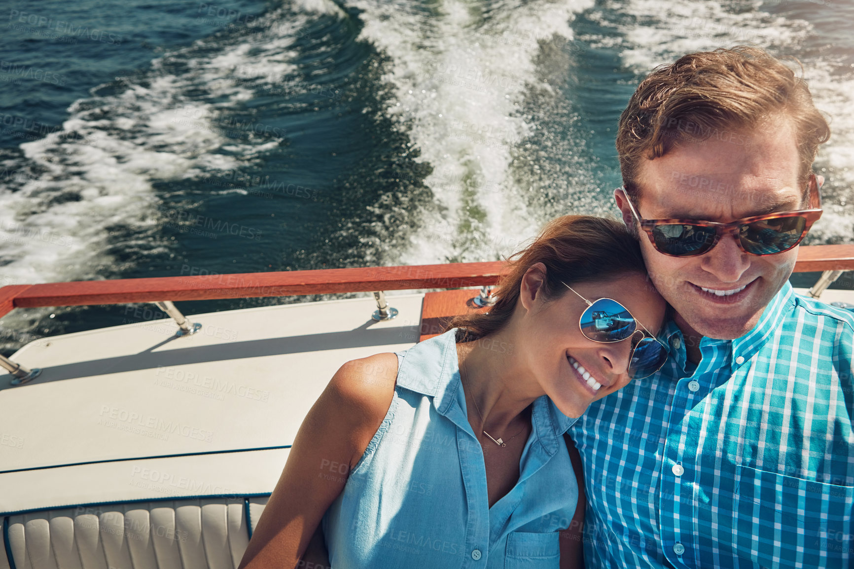 Buy stock photo Shot of a young couple spending time together on a yacht