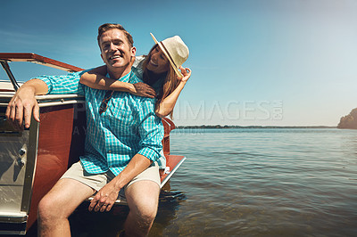 Buy stock photo Shot of a young couple spending time together on a yacht