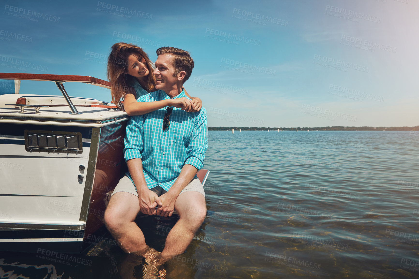 Buy stock photo Shot of a young couple spending time together on a yacht