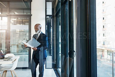 Buy stock photo Cropped shot of a mature businessman working in a modern office