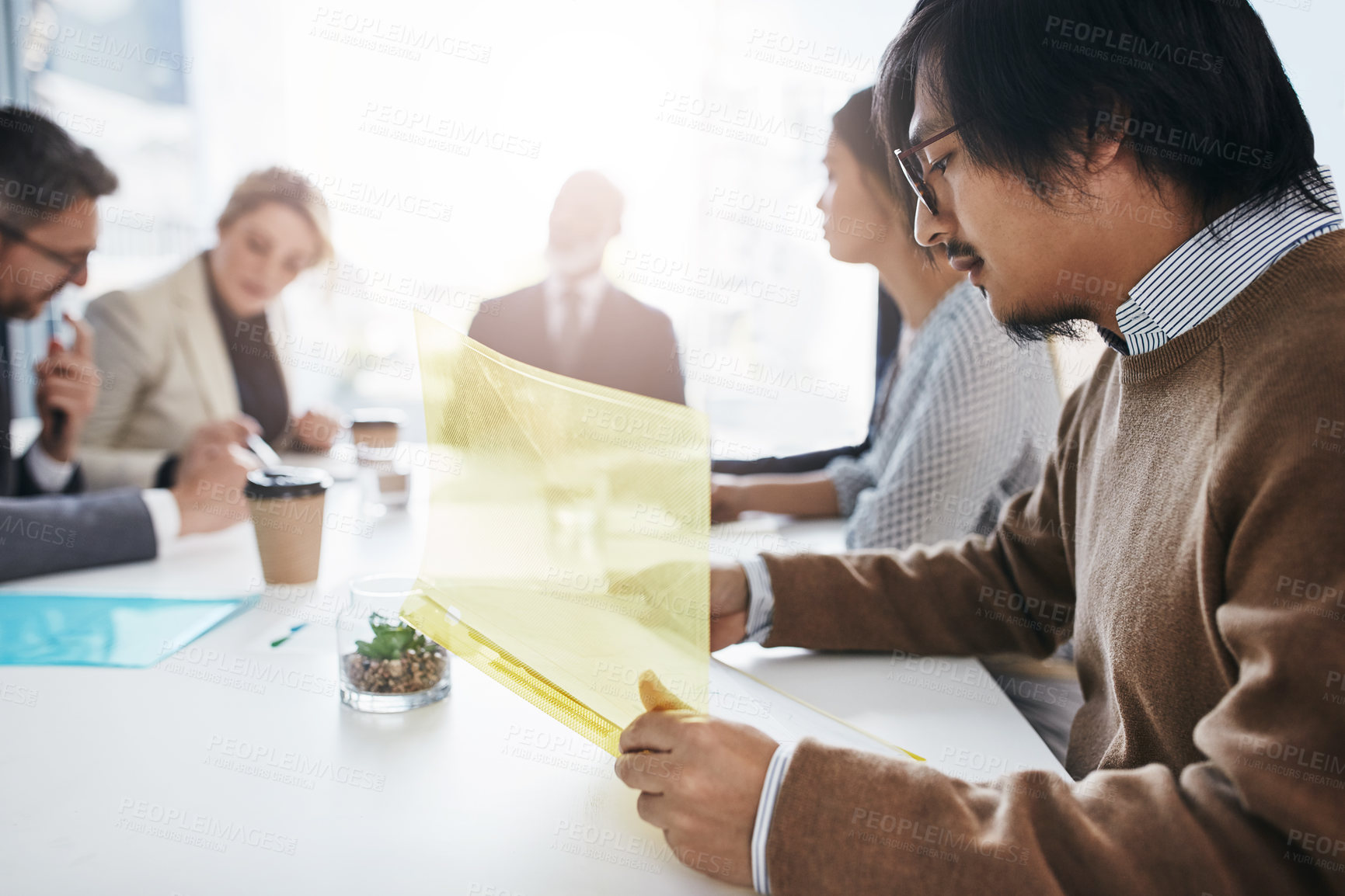 Buy stock photo Shot of a group of businesspeople having a meeting in an office