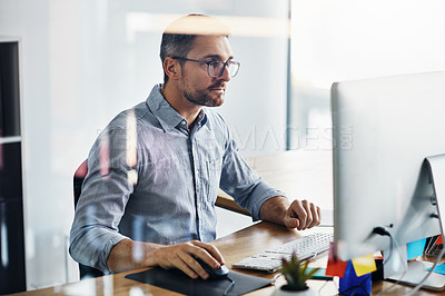 Buy stock photo Cropped shot of a businessman working on his computer at his desk