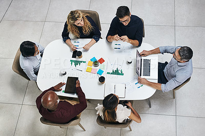 Buy stock photo High angle shot of a group of businesspeople having a meeting in an office