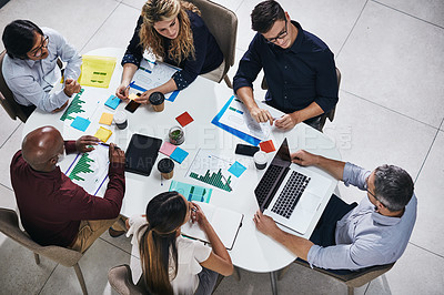 Buy stock photo Meeting, discussion and top view of a team planning in a company report or proposal in the office. Teamwork, diversity and marketing employees working on a creative project together in the workplace.