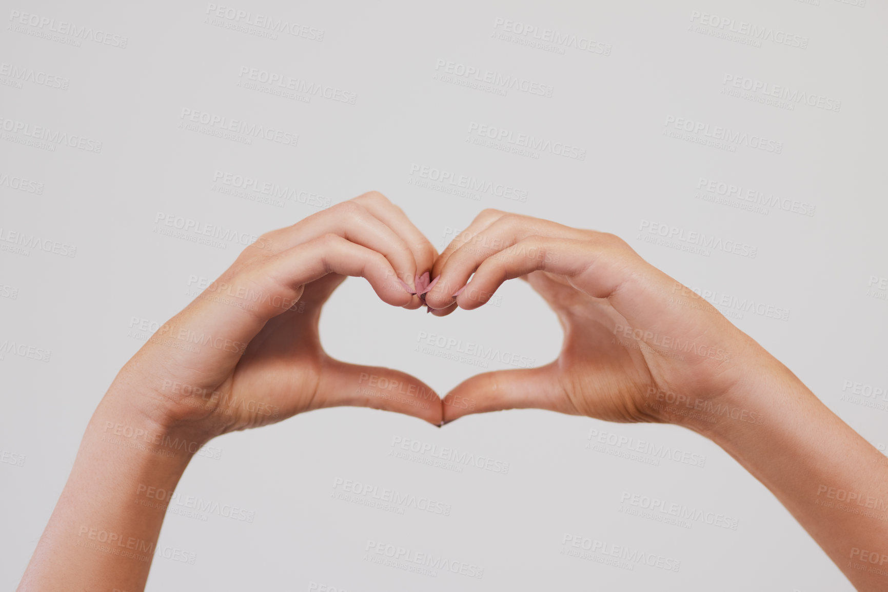 Buy stock photo Closeup, heart or hands in studio for love, charity or health insurance isolated on gray background. Peace, fingers or woman with sign for romance, care or show emoji gesture for kindness or donation