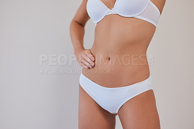 Buy stock photo Studio shot of an unrecognizable woman posing against a grey background with one hand on her hip