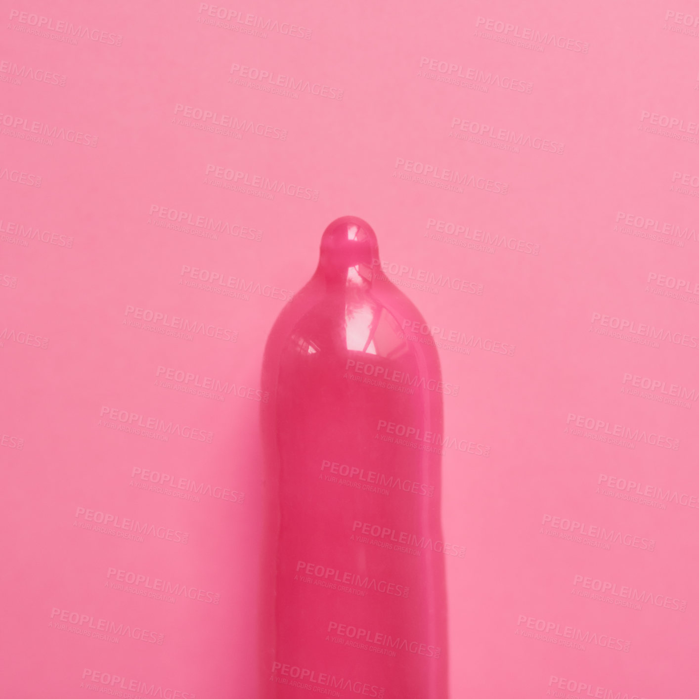 Buy stock photo Pink, condom or safety with latex for education, sexual health or STD awareness. Contraception, wellness or responsibility on studio background for creativity, HIV prevention or rubber for protection