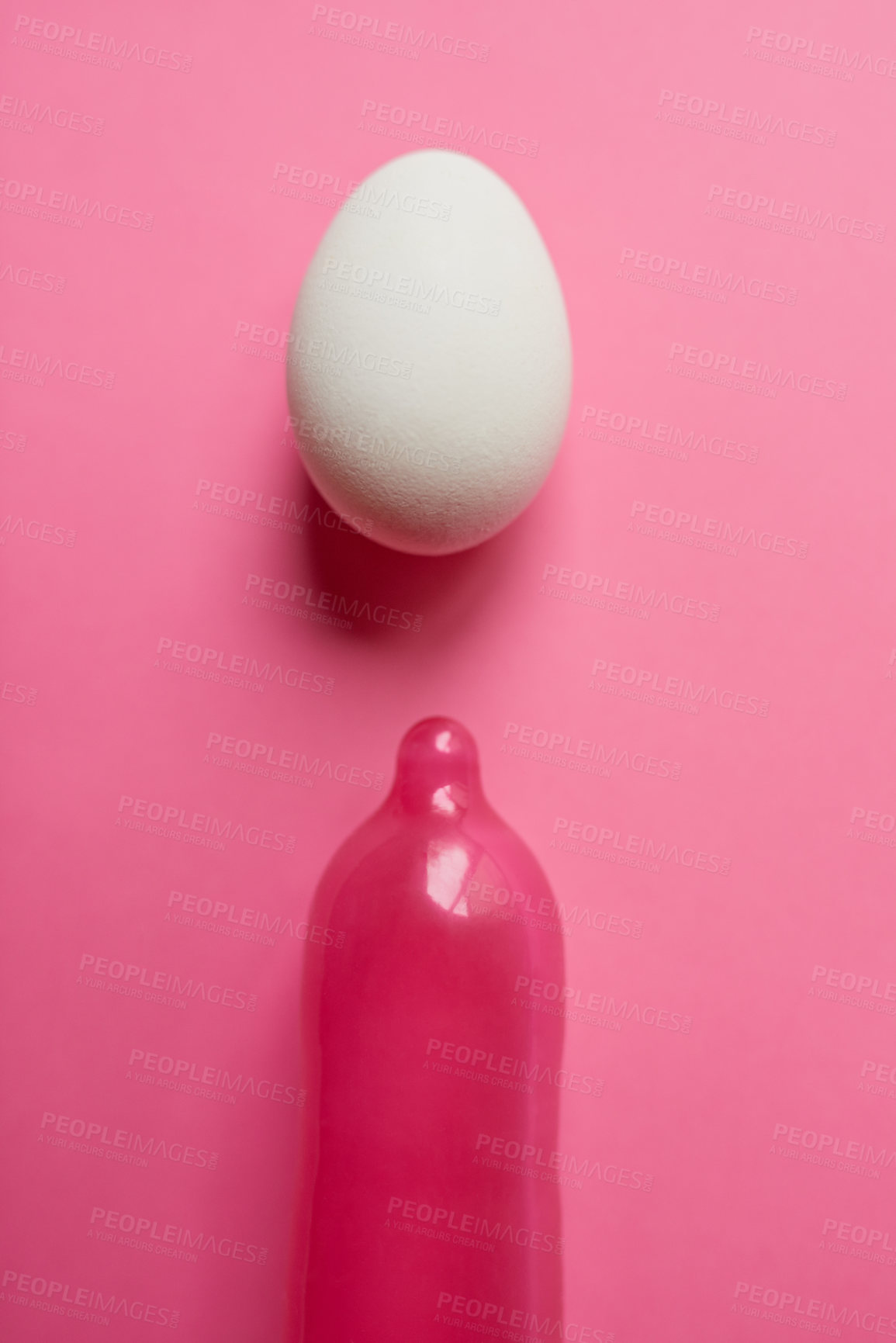 Buy stock photo Egg, condom and studio background as contraceptive for birth rate, reproduction and protection. Embryo, safety and prevention for pregnancy to manage or control fertility of new life and future