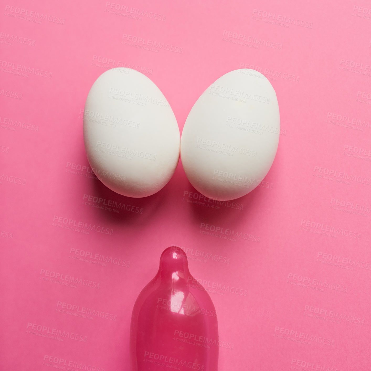 Buy stock photo Eggs, condom and studio background as protection for birth rate, reproduction and contraceptive. Embryo, safety and prevention for pregnancy to manage fertility for new life and control population