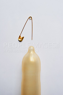 Buy stock photo Above, needle and risk with condom in studio for pregnancy, sexually transmitted disease and danger. Contraceptive, safety and sex education with protection on white background for sti prevention