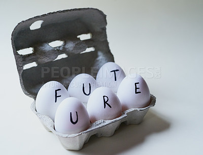 Buy stock photo Studio shot of a box against a grey background containing half a dozen eggs with the word future written on it