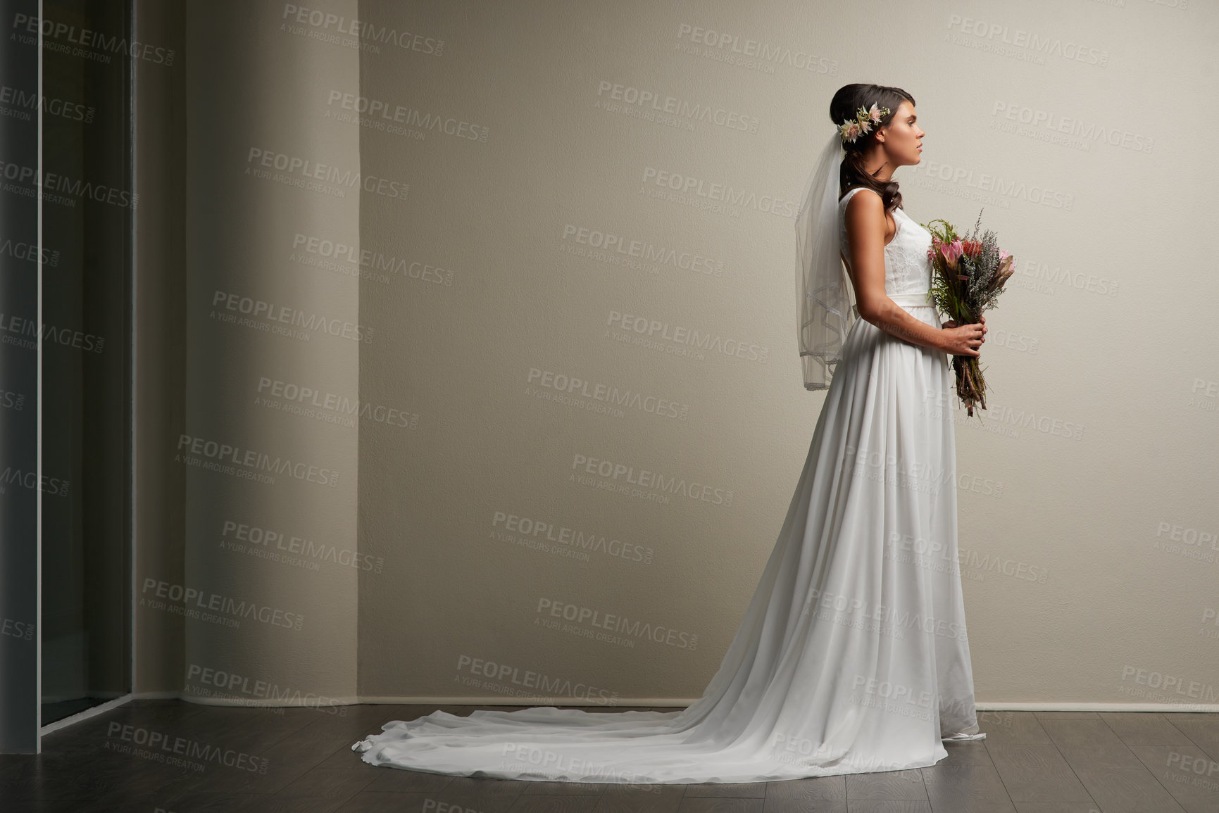 Buy stock photo Studio shot of a young beautiful bride posing against a grey background