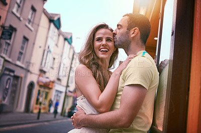 Buy stock photo Travel, couple and love with kiss, smile and urban journey on holiday, adventure or honeymoon. Vacation, man and happy woman with romance in city for Europe, street tourism and sightseeing together