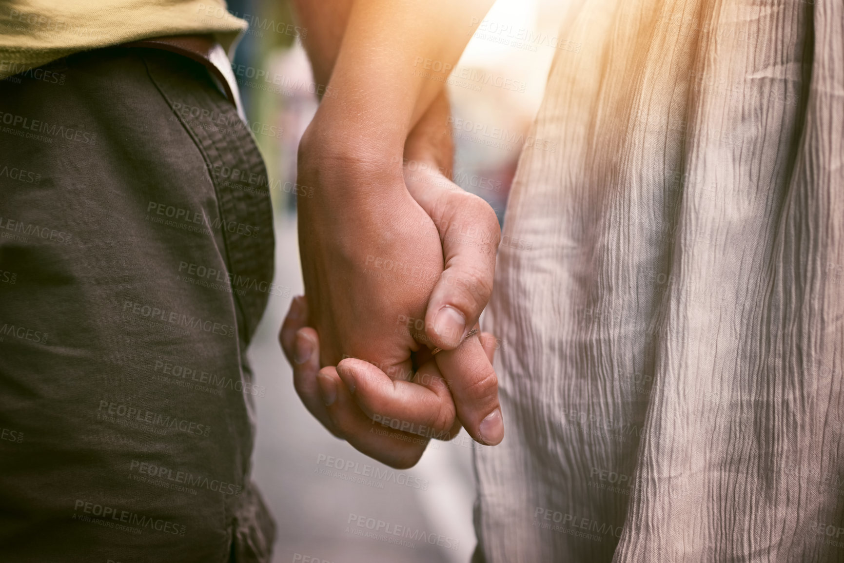 Buy stock photo Cropped shot of an affectionate couple holding hands outdoors