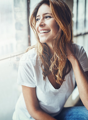 Buy stock photo Shot of an attractive and thoughtful young woman relaxing at home