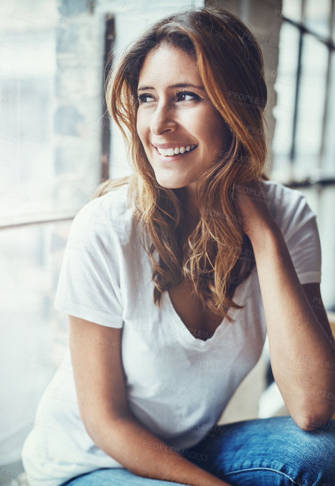 Buy stock photo Shot of an attractive and thoughtful young woman relaxing at home