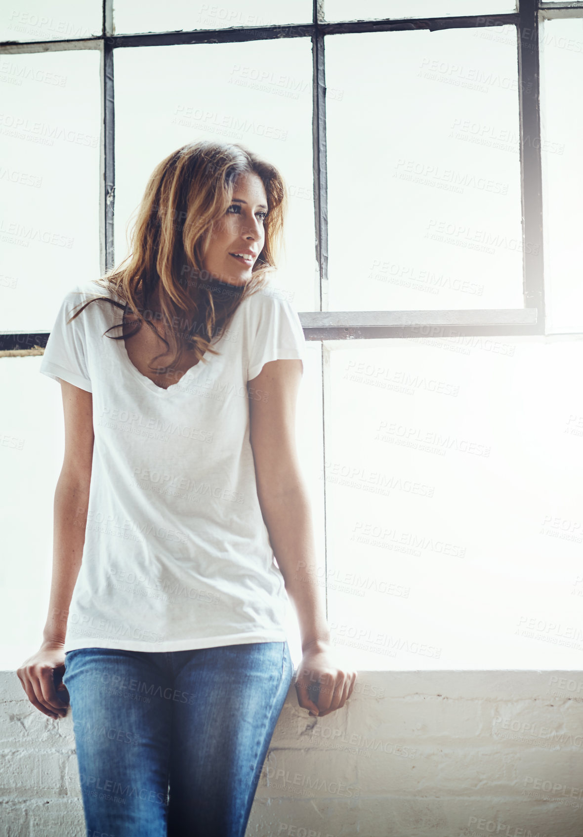 Buy stock photo Shot of an attractive and thoughtful young woman relaxing at home