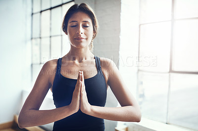 Buy stock photo Shot of an attractive young woman practising yoga at home