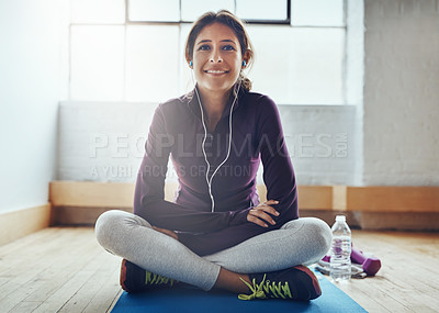 Buy stock photo Portrait of an attractive young woman listening to music while working out at home