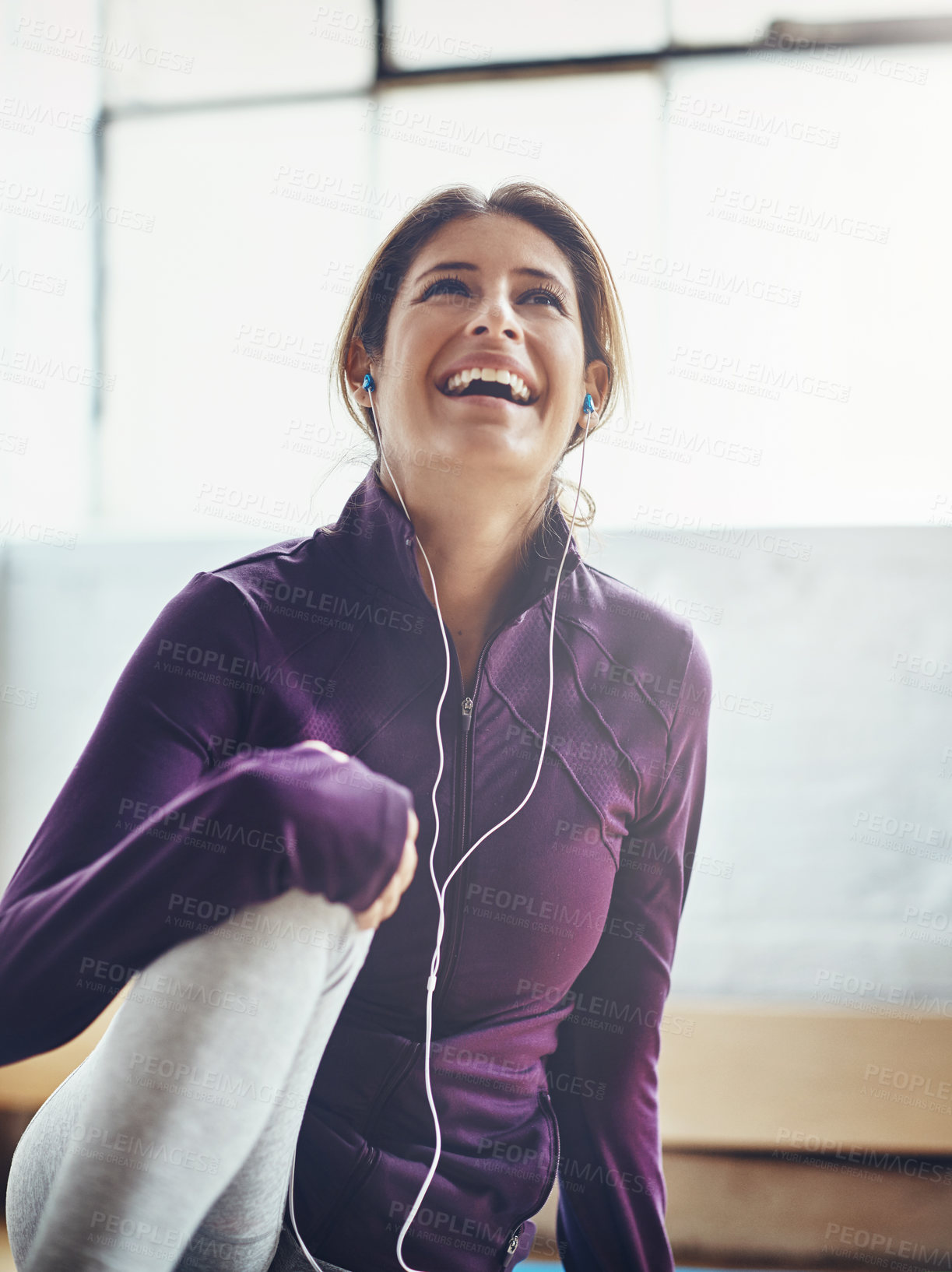 Buy stock photo Shot of an attractive young woman listening to music while working out at home