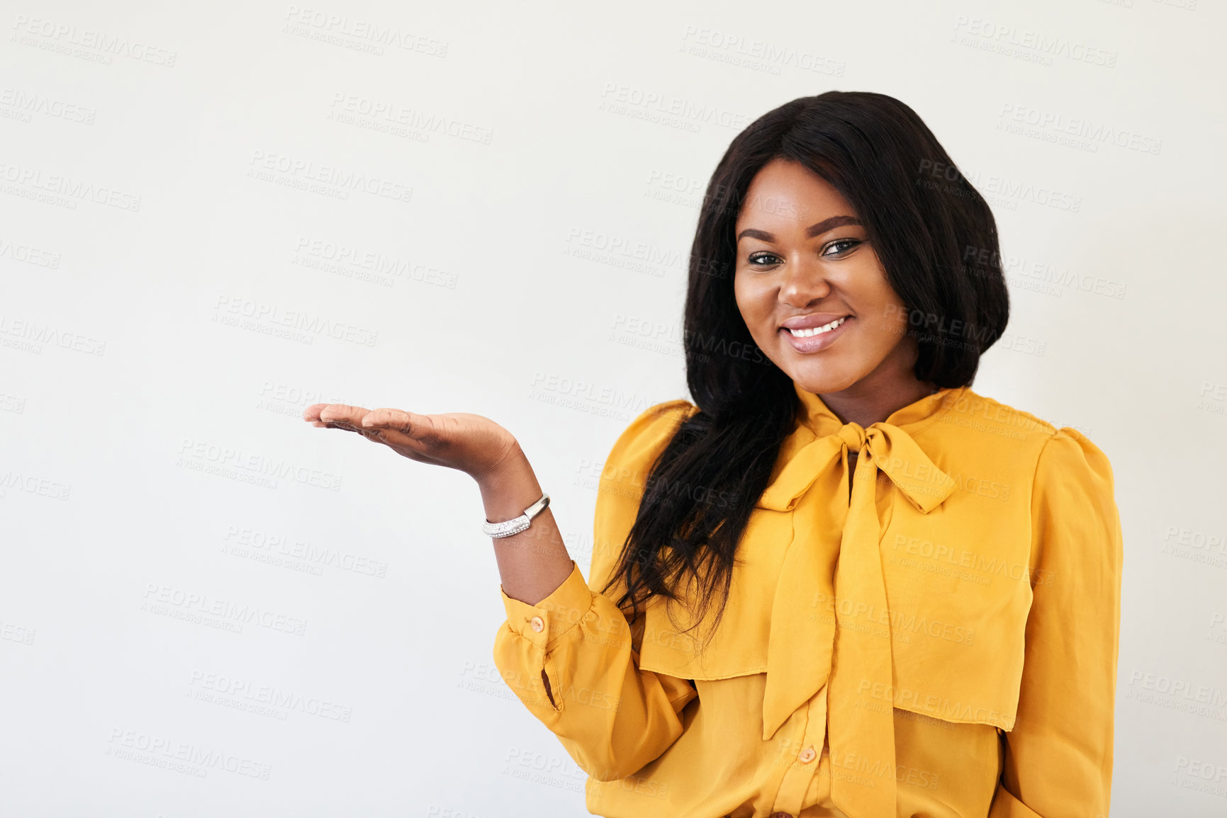 Buy stock photo Studio portrait of a cheerful young woman standing with her  hand raised against a white background