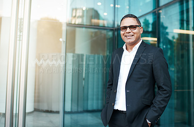 Buy stock photo Cropped portrait of a handsome mature businessman standing on the street with his office in the background