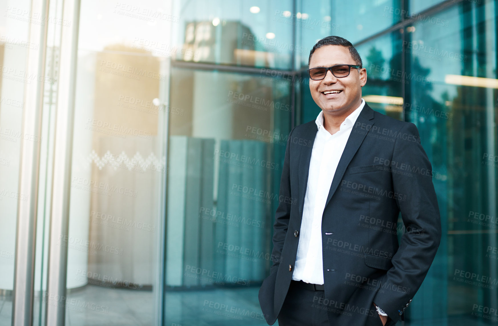 Buy stock photo Cropped portrait of a handsome mature businessman standing on the street with his office in the background