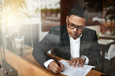 Buy stock photo Businessman, corporate paperwork and writing in cafe for lawyer contract, legal document and glasses. Paralegal, person and review for insurance claim, investment policy and remote work by window