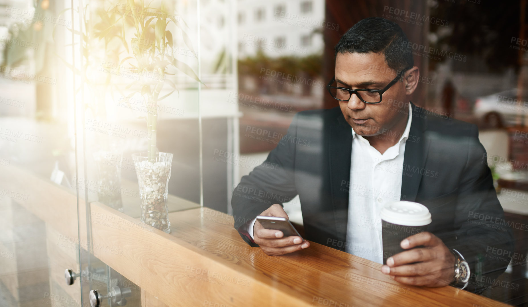 Buy stock photo Phone, coffee and businessman in cafe reading online news with mobile app, website or internet. Communication, technology and male person typing email on cellphone with cappuccino in restaurant.