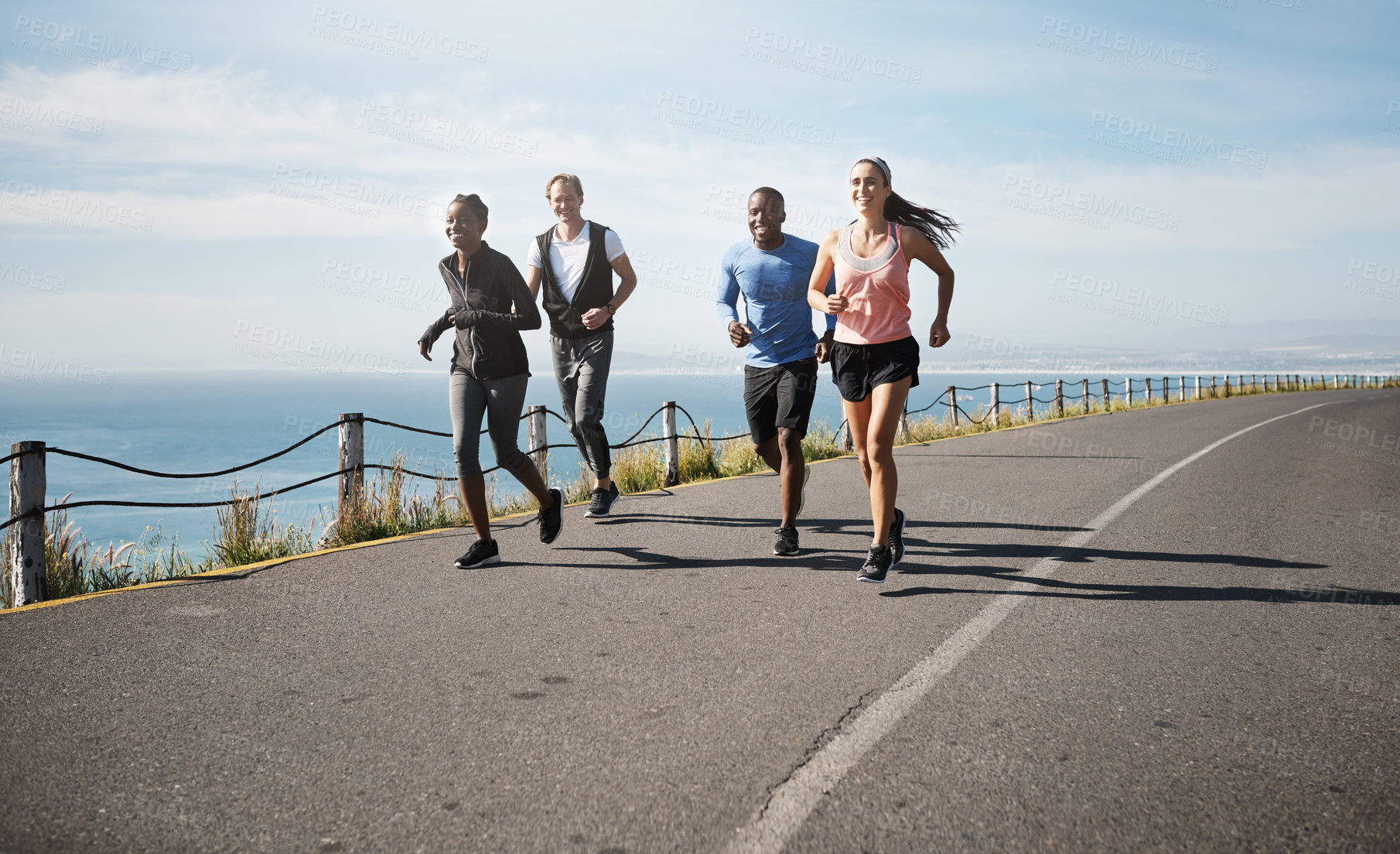 Buy stock photo Shot of a group of people out running together