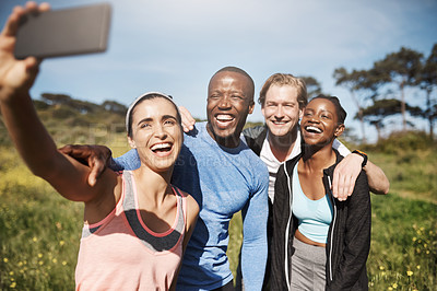 Buy stock photo Shot of a group of friends taking a selfie outdoors after their workout