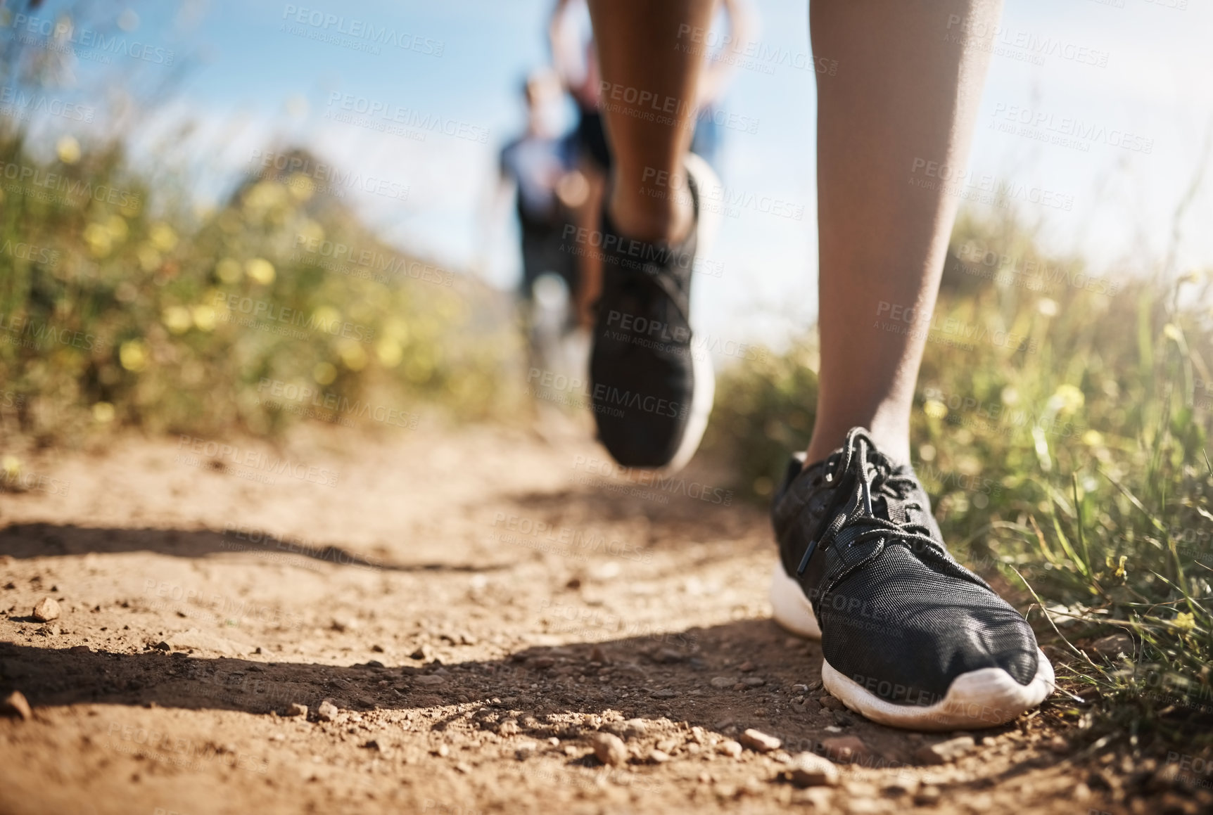 Buy stock photo Fitness, people and feet running on mountain for cardio workout, competition training and challenge. Teamwork, shoes and morning jog in nature for marathon exercise, endurance or healthy body on path