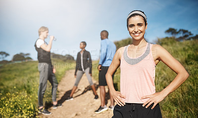 Buy stock photo Portrait of a young woman exercising outside with people in the background