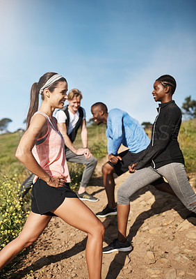 Buy stock photo Shot of a fitness group stretching before their run