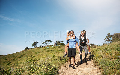 Buy stock photo Shot of two men challenging each other by carrying their girlfriends downhill