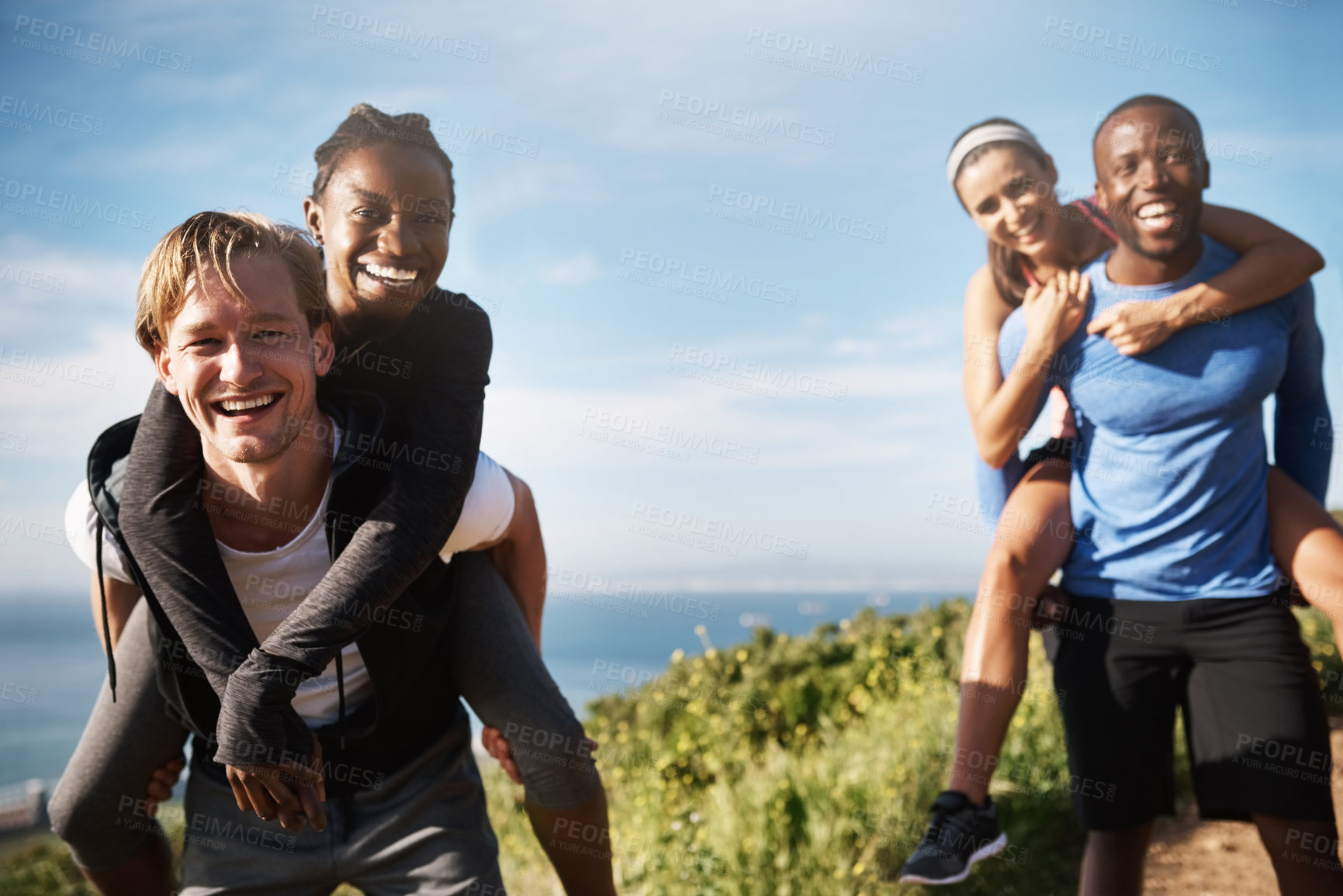 Buy stock photo Portrait, couple and piggyback for hiking outdoor with fitness challenge, mountain travel and trekking journey. Smile, diversity and people walk for exercise, blue sky and bonding adventure of health