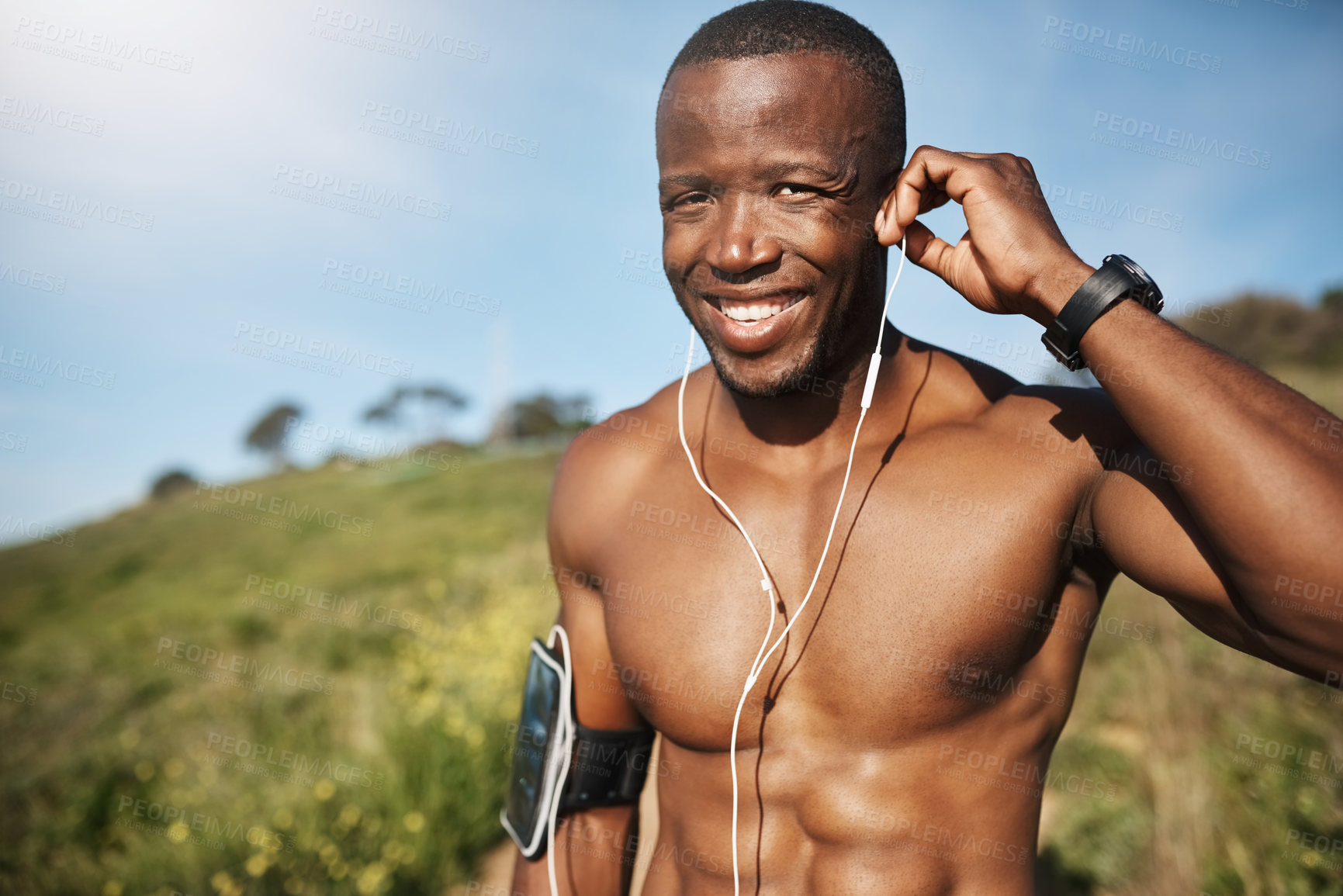 Buy stock photo Cropped shot of a man listening to music while out for a run