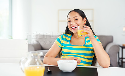 Buy stock photo Portrait of a happy young girl enjoying a healthy breakfast at home