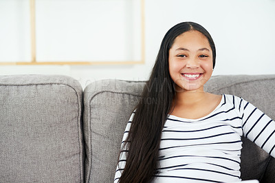 Buy stock photo Portrait of a happy young girl relaxing on the sofa at home