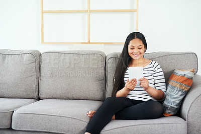 Buy stock photo Child, tablet and sofa at home with elearning, online education and upskill app game. Living room, tech and digital reading with social media or youth development learning in a house with smile