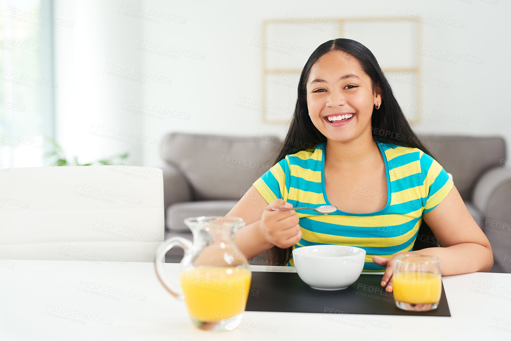 Buy stock photo Portrait, happy girl and smile in home with breakfast, juice and excited for healthy diet in morning. Nutrition, growth and development, hungry child at table with cereal and drink at start of day